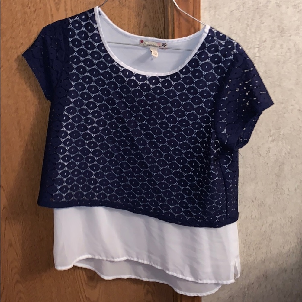 A white blouse with a blue see through blouse.
